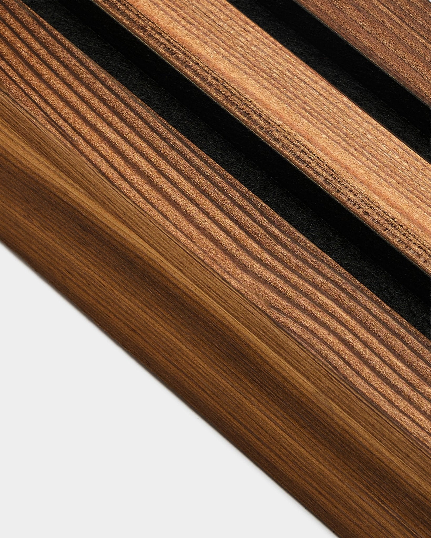 Vue détaillée de la lamelle de finition WoodUpp en mélèze fumé rustique, 6,7 cm, conçue pour finir les bords des Akupanel Panneau acoustique sur des murs de teinte claire.