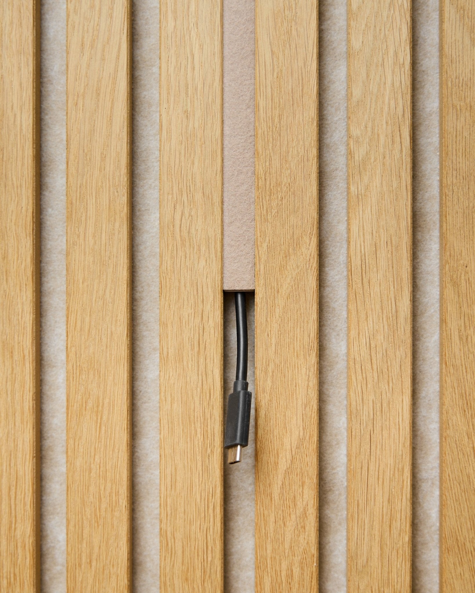 Dupps Pop-on-Kabelabdeckung (beige, 3er-Set) von WoodUpp verdeckt Kabel zwischen Akustikpaneel-Lamellen, sodass nur der Anschluss für ein aufgeräumtes Finish sichtbar bleibt.