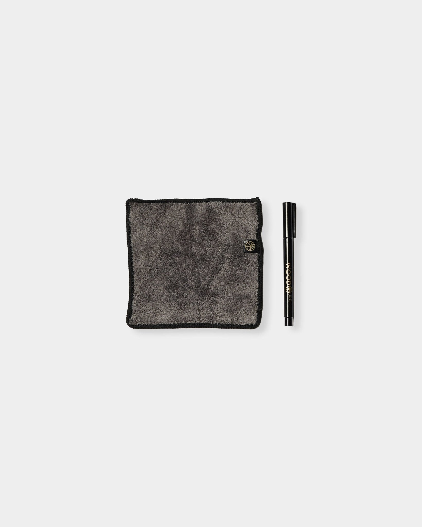 Das Norr Blackboard-Set von WoodUpp besteht aus einem grauen Mikrofasertuch mit blacken Kanten und einem Kreidemarker und ist für die Verwendung auf magnetischen Akustikpaneelen konzipiert.