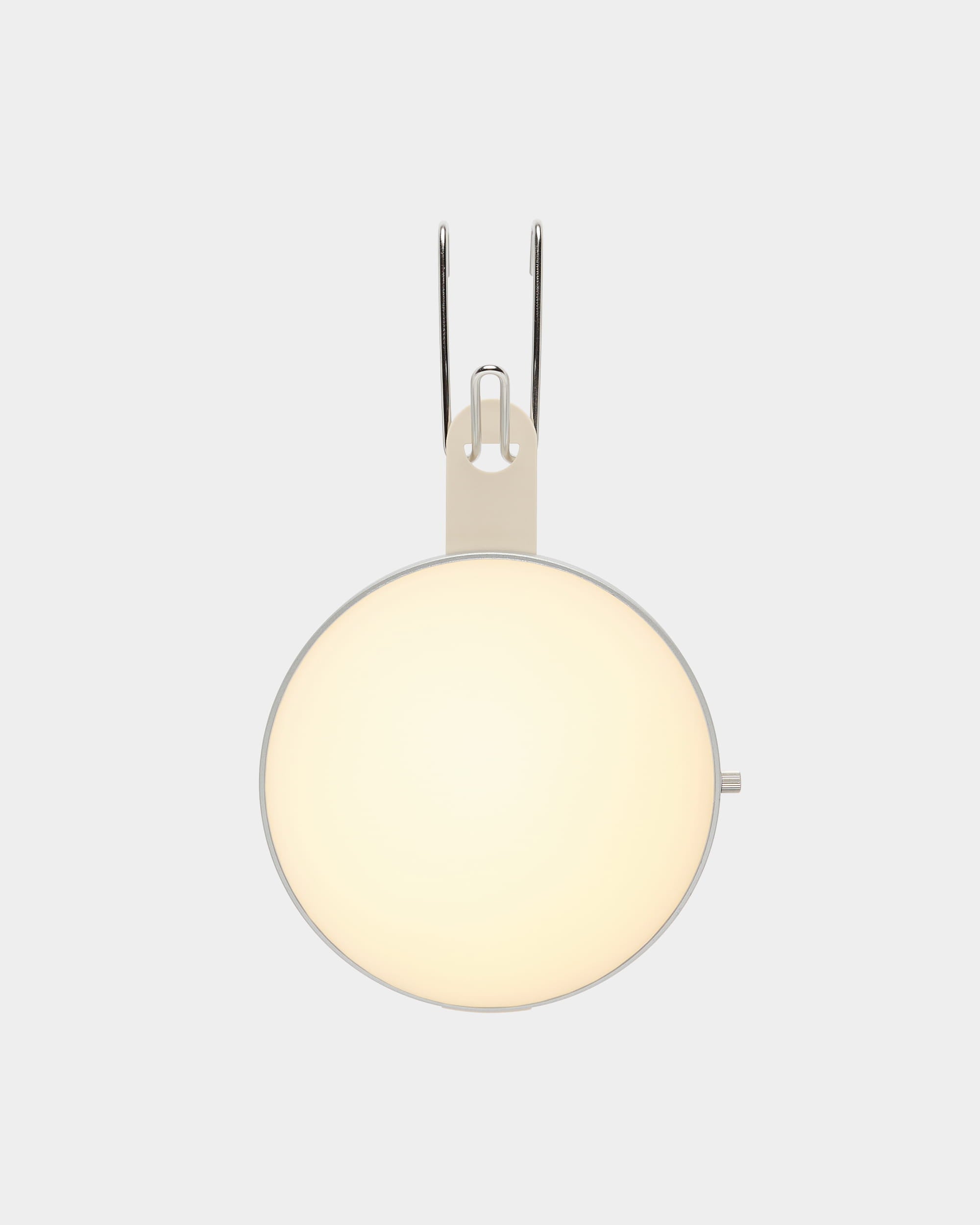 Die tragbare LED-Lampe „WoodUpp Vala“ mit mattiertem Glasschirm und Metallhalterung, montiert an einer hellgrauen Wand, unterstreicht das minimalistische nordische Design.